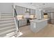 Contemporary kitchen with stainless steel appliances, light grey cabinets, island, and wood floors at 2225 Millbank Village Ct # 101, Raleigh, NC 27610