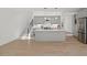 Bright open-concept kitchen featuring stainless steel appliances, island and light wood floors at 2225 Millbank Village Ct # 101, Raleigh, NC 27610