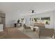 Bright, open living room with modern furnishings, large windows, and wood flooring at 2225 Millbank Village Ct # 101, Raleigh, NC 27610