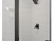 Modern shower featuring white subway tile, a glass door, and matte black fixtures at 2225 Millbank Village Ct # 101, Raleigh, NC 27610