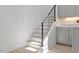 Staircase with hardwood steps, black metal railing, and modern design at 2225 Millbank Village Ct # 101, Raleigh, NC 27610