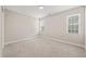 Cozy bedroom featuring carpeted floors, neutral walls, moon/stars wall decor, and two windows for natural light at 225 East End Ave, Durham, NC 27703