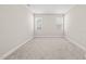 Bright bedroom features carpeted floors, neutral walls and trim, and two windows for natural light at 225 East End Ave, Durham, NC 27703