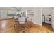 Open dining area with kitchen, laundry room, dining table, hardwood floor, and white cabinetry at 225 East End Ave, Durham, NC 27703