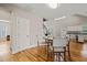 Open dining area featuring access to kitchen and staircase, hardwood flooring, and modern finishes at 225 East End Ave, Durham, NC 27703