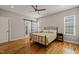 Serene primary bedroom with hardwood floors, ceiling fan, and a sliding barn door that leads to the bath at 225 East End Ave, Durham, NC 27703