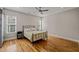 Bright primary bedroom featuring hardwood floors, ceiling fan, and a cozy atmosphere at 225 East End Ave, Durham, NC 27703