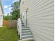 Side entrance to the home features a small porch with stairs, offering a convenient access point at 225 East End Ave, Durham, NC 27703