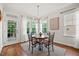 Bright breakfast nook features a modern chandelier, three large windows, and a door to the patio at 2256 Toad Hollow Trl, Apex, NC 27502