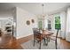 Inviting dining area with a round table, modern chandelier, and a view to the outdoor patio at 2256 Toad Hollow Trl, Apex, NC 27502