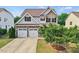 Attractive home with a two-car garage, manicured lawn, and well-maintained landscaping at 2256 Toad Hollow Trl, Apex, NC 27502