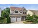 Charming two-story home with a stone facade, attached two-car garage, and beautifully landscaped front yard at 2256 Toad Hollow Trl, Apex, NC 27502