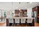 Bright kitchen features a spacious island with barstool seating and modern pendant lighting at 2256 Toad Hollow Trl, Apex, NC 27502