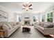 Spacious living room features neutral tones, large windows, fireplace, and comfortable seating at 2256 Toad Hollow Trl, Apex, NC 27502