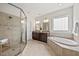 Main bathroom features double vanity, soaking tub, and glass shower at 2256 Toad Hollow Trl, Apex, NC 27502