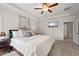 Cozy main bedroom suite with tray ceiling, carpeted floors, and neutral decor offers a relaxing retreat at 2256 Toad Hollow Trl, Apex, NC 27502