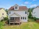 View of the home's back exterior with a screened porch and well-maintained lawn at 2256 Toad Hollow Trl, Apex, NC 27502