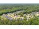 Aerial view of a peaceful neighborhood nestled among lush green trees and winding streets at 2328 Sanctuary Dr, Raleigh, NC 27606