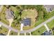 Bird's-eye view of a property with a large yard, a fire pit area, and a sprawling lawn surrounded by trees at 2328 Sanctuary Dr, Raleigh, NC 27606