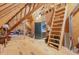 Spacious unfinished attic showcasing exposed wooden beams and ladder to the loft with additional space for storage at 2328 Sanctuary Dr, Raleigh, NC 27606