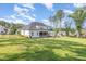 Sprawling backyard with ample space for recreation, featuring a covered porch and a cozy fire pit area at 2328 Sanctuary Dr, Raleigh, NC 27606