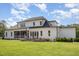 Expansive backyard featuring a well-manicured lawn, a fire pit, and a charming patio area perfect for entertaining at 2328 Sanctuary Dr, Raleigh, NC 27606