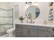 Inviting bathroom with white counters, gray cabinets, modern fixtures and natural light at 2328 Sanctuary Dr, Raleigh, NC 27606