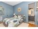 Inviting bedroom with en suite bathroom, hardwood floors and neutral colors at 2328 Sanctuary Dr, Raleigh, NC 27606