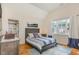 Bright bedroom with a vaulted ceiling, a wooden bed frame, and a window, providing a peaceful and airy space at 2328 Sanctuary Dr, Raleigh, NC 27606