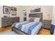 Bedroom with a wooden bed, decor art, and side tables, offering a serene atmosphere and ample storage at 2328 Sanctuary Dr, Raleigh, NC 27606