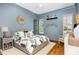 Stylish bedroom featuring hardwood floors, blue walls, ceiling fan and two windows at 2328 Sanctuary Dr, Raleigh, NC 27606