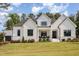 Beautiful modern farmhouse with a covered porch, stylish black accents, and well-manicured landscaping at 2328 Sanctuary Dr, Raleigh, NC 27606
