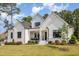 Charming modern farmhouse with covered porch, black-trimmed windows, and professionally landscaped front yard at 2328 Sanctuary Dr, Raleigh, NC 27606