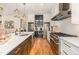 Gourmet kitchen with stainless appliances, white cabinets and center island with sink at 2328 Sanctuary Dr, Raleigh, NC 27606