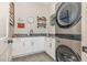 Convenient laundry room featuring stacked washer and dryer, ample counter space, and modern fixtures at 2328 Sanctuary Dr, Raleigh, NC 27606
