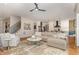 Open-concept living room flowing into kitchen, featuring hardwood floors, fireplace, and comfortable seating at 2328 Sanctuary Dr, Raleigh, NC 27606