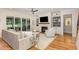 Bright living room with hardwood floors, fireplace, built-in shelves, and sliding glass doors to the backyard at 2328 Sanctuary Dr, Raleigh, NC 27606