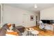 Cozy living room with a comfortable leather couch, round side tables, and a dedicated workspace, blending relaxation at 2328 Sanctuary Dr, Raleigh, NC 27606
