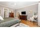 This bright main bedroom features hardwood floors, ceiling fan, and natural light at 2328 Sanctuary Dr, Raleigh, NC 27606