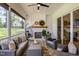 Inviting covered patio with a stone floor, fireplace, seating and a ceiling fan, perfect for outdoor relaxation at 2328 Sanctuary Dr, Raleigh, NC 27606