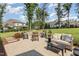 Inviting outdoor patio with stylish seating and a lush green lawn surrounded by mature trees at 2328 Sanctuary Dr, Raleigh, NC 27606