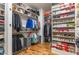 Organized walk-in closet with custom shelving, hanging racks, and hardwood floors at 2328 Sanctuary Dr, Raleigh, NC 27606