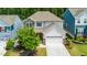 An aerial view of a well-maintained two-story house with a manicured lawn and an attached two-car garage at 2619 Bordwell Grant Dr, New Hill, NC 27562