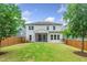 Back exterior shows a two-story home, a screened porch, and a fenced yard, perfect for outdoor enjoyment and privacy at 2619 Bordwell Grant Dr, New Hill, NC 27562