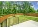 A large, fenced backyard with a concrete patio offers ample space for outdoor activities and relaxation at 2619 Bordwell Grant Dr, New Hill, NC 27562