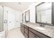 Bathroom featuring double vanity with granite countertops and framed mirrors at 2619 Bordwell Grant Dr, New Hill, NC 27562