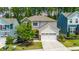 A charming two-story home with stone accents, an attached garage, and lush landscaping enhances curb appeal at 2619 Bordwell Grant Dr, New Hill, NC 27562