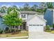 Charming two-story home featuring a two-car garage, brick accents, and a well-manicured lawn at 2619 Bordwell Grant Dr, New Hill, NC 27562