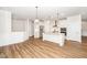 Bright, white kitchen featuring stainless steel appliances, an island, and a seamless open layout at 2619 Bordwell Grant Dr, New Hill, NC 27562