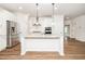 Bright kitchen features stainless steel appliances, white cabinets, and granite countertops at 2619 Bordwell Grant Dr, New Hill, NC 27562